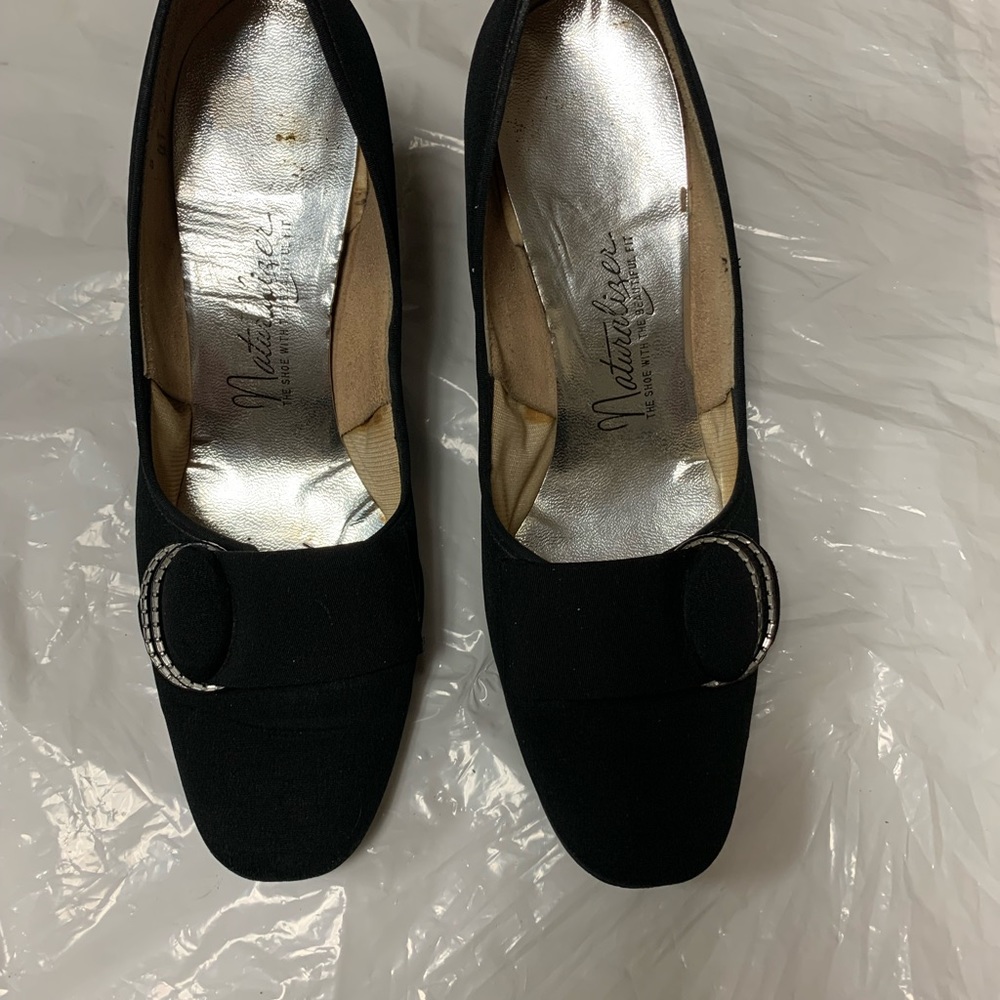 Naturalizer women dress low heel pump in black. Top is upholstered taffeta.